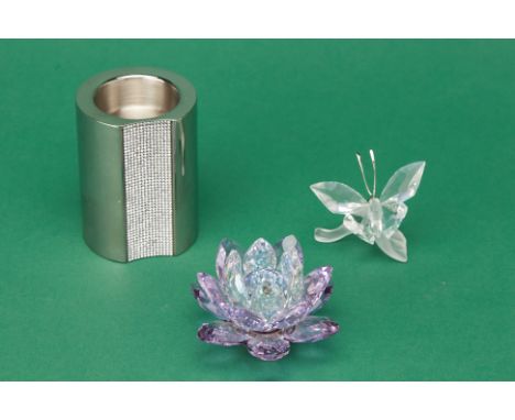 THREE SWAROVSKI ITEMS
Consisting of a butterfly on a leaf sculpture, a flower-shape and cylindrical-shape candle holder. All 