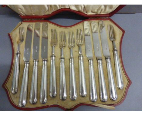 A cased set of of silver dessert 6 fork and 6 knives, in a red leather fitted case, Sheffield 1927