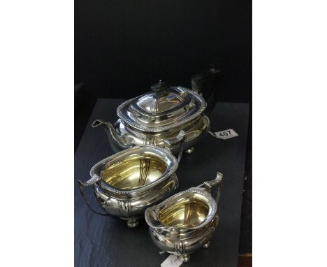 A three piece silver tea service, with gadroon border, ebony handle and finial, Sheffield 1910