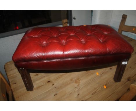 AN OXBLOOD CHESTERFIELD FOOT STOOL