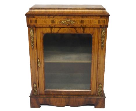 A French rosewood display cabinet the canted rectangular top above a narrow drawer and glazed door flanked by cast brass foli