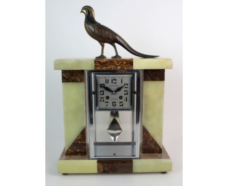 An Art Deco mixed onyx and glass mantle clock the rectangular case of glass and chrome with square dial with Arabic numerals,