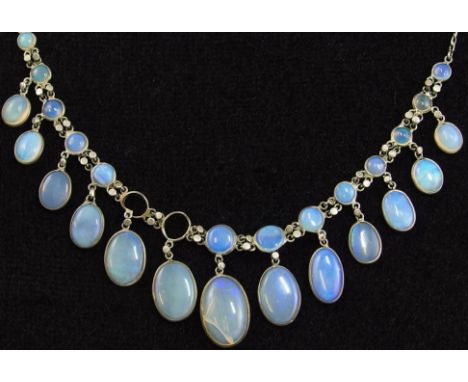 An opal festoon necklace all the opals are set in open back spectacle mounts with  decorative links in between, opals are the