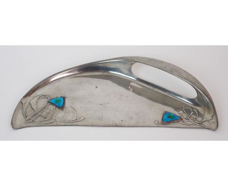 A Liberty & Co. Tudric pewter and enamel crumb tray half moon-form with integrated handle to rim, two applied enamelled blue 