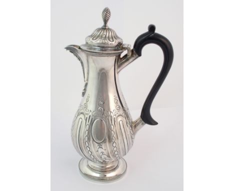 A Victorian silver coffee pot by Thomas Bradbury & Sons, London 1885, of baluster form with half spiral fluted body, foliate 