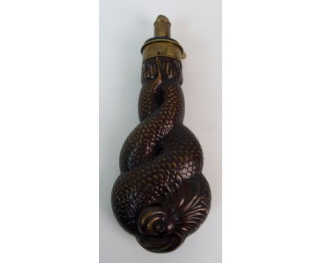 A 19th Century powder flask the copper body modelled as a stylised dolphin, 21cm long