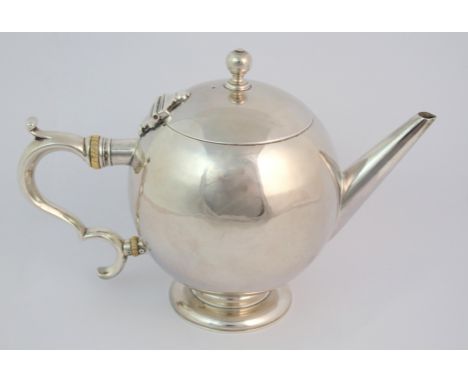 A silver teapot by Crichton Brothers (Lionel Alfred Crichton), London 1933, of bullet shape with ball finial and looping hand