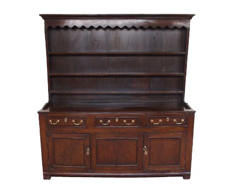 An 18th Century and later oak and mahogany crossbanded dresser (possibly Yorkshire), the plate rack with dentil frieze above 