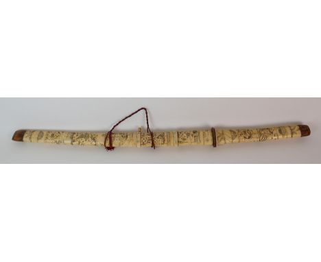 A Japanese sword the bone segmented hilt and scabbard carved with various figures amid buildings, the blade 49.5cm long, 86cm