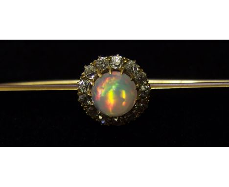 A fiery high cabouchon opal and old cut diamond bar brooch the opal is approximately 7mm x 5mm, is fine claw set and encircle