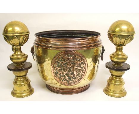 A Dutch brass planter with applied armorial plaque flanked by lion ring masks, 44cm diameter and a pair of brass and steel an