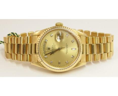 A Gent's 18ct Rolex Oyster perpetual Day-Date the gold champagne coloured dial is stamped Rolex Oyster Perpetual Day-Date, Su