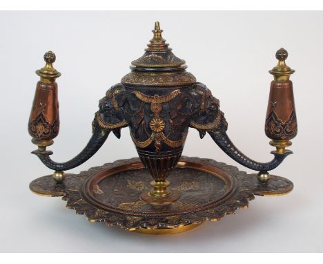 An Elkington & Co. mixed metal figural smoker's set in the Indian taste, central urn with elephant trunk arms to either side 