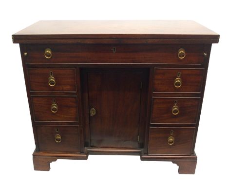 A mahogany pedestal writing desk the fold-over top above a long drawer flanked by three graduating drawers and a kneehole doo