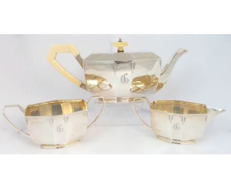 A three piece silver tea service by Emile Viner, Sheffield 1935, of elongated octagonal shape with ivory handle and finial on