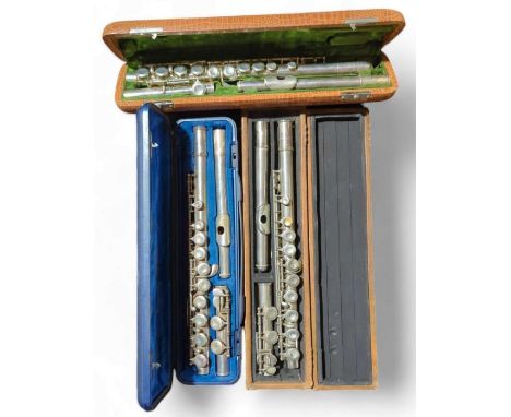A silver plated flute by J R Lafleur & Son in case together with two other cased flutes (3) 
