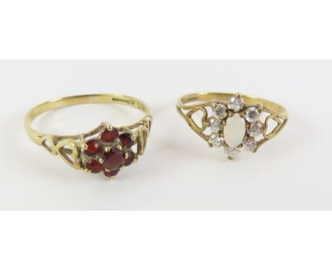 A 9ct gold garnet set dress ring, finger size O 1/2; and a 9ct gold opal and CZ dress ring, finger size M; 2.6g gross