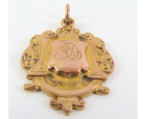 A 9ct gold fob medal, the front with usual engraved decoration and monogrammed cartouche, the back with the inscription - BOT