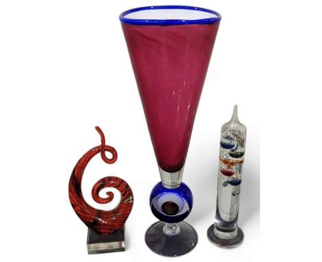 A large coloured art glass vase, 49cms high, a sculpted glass ornament and a glass barometer (3)