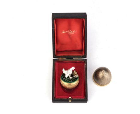 A BOXED SILVER GILT AND ENAMEL SURPRISE EGG, STUART DEVLIN, LONDON, EARLY 20TH CENTURY the egg opening to reveal an emerald g