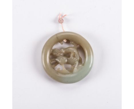 A CHINESE CELADON JADE ‘QILIN’ PENDANT circular, carved to the centre with a horned qilin trotting on waves with a lingzhi it