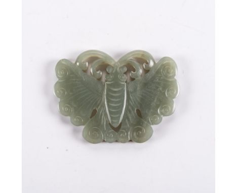 A CHINESE CELADON JADE ‘BUTTERFLY’ PENDANT, LATE 19TH/EARLY 20TH CENTURY the segmented wings carved with fine veins above a s