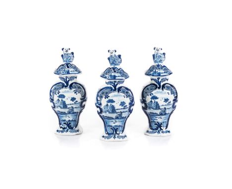 A DUTCH DELFT THREE PIECE GARNITURE SET, CIRCA 1900 each baluster-shaped body painted to one side with a shaped panel enclosi