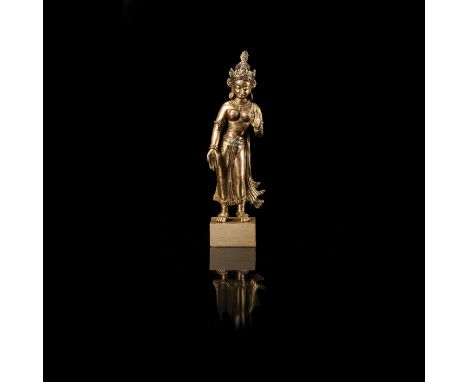 A TIBETO-CHINESE GILT COPPER-ALLOY FIGURE OF TARA, LATE 19TH/EARLY 20TH CENTURY standing with exposed breasts, the fitting dh