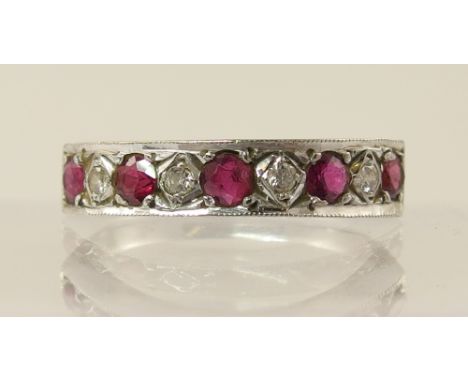 An 18ct white gold ruby and diamond half eternity ring