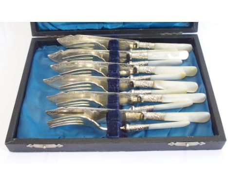 A cased 12 piece EPNS and mother of pearl handled fish cutlery set each piece with embossed scroll and foliate collar, the kn