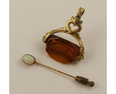 A yellow metal opal set stick pin and a decorative glass swivel fob