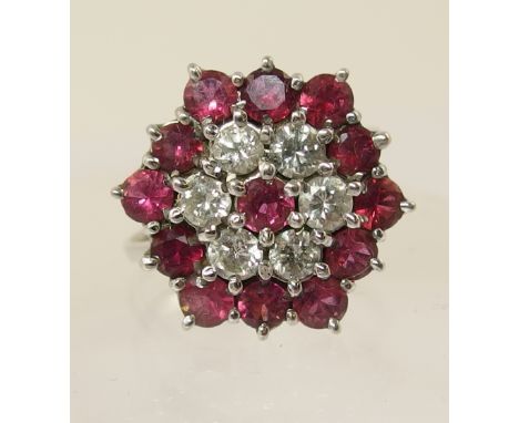 A ruby and diamond flower cluster ring. Diamond combined total approx 0.60cts