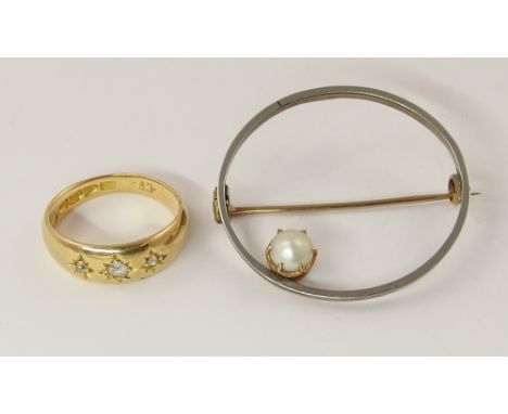 An 18ct gypsy set three stone diamond ring and a yellow and white metal brooch set with a pearl