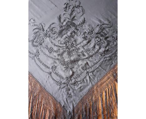 A black silk embroidered and tasselled crinoline shawl with machine embroidered floral swirls and leaves to each corner, 65" 