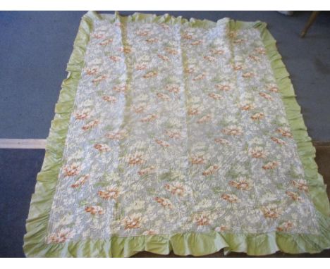 A vintage Welsh handmade and reversible single bed spread having a floral centre on a grey ground with ruffled green border t