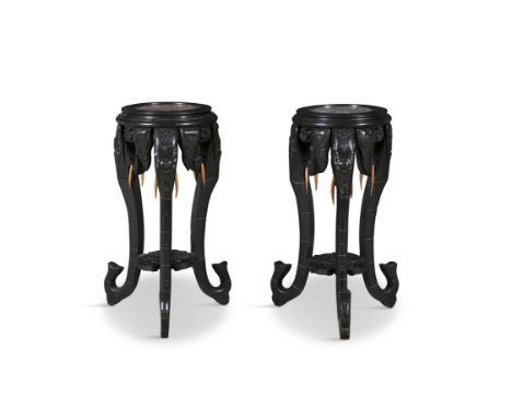 A PAIR OF CHINESE EBONISED AND MARBLE TOP JARDINIERE STANDS, c. 1900, each circular rouge marble top supported on three eleph