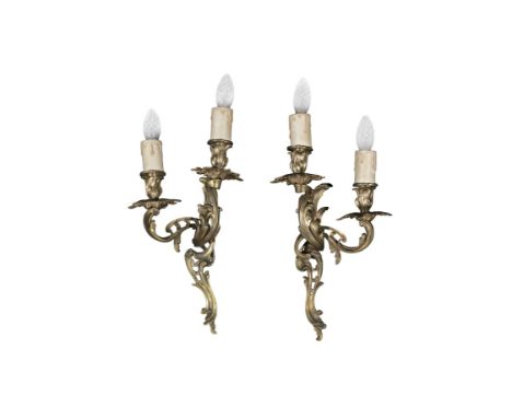 A PAIR OF CAST BRASS TWIN LIGHT WALL SCONCES,in the Rococo taste, modelled as scrolling leaves and flowerhead lights fitted 
