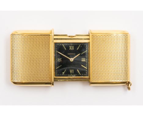 A MOVADO ERMETO GOLD FOLDING TRAVEL WATCHThe signed square black dial with gilt Roman and baton hour markers, the exterior en