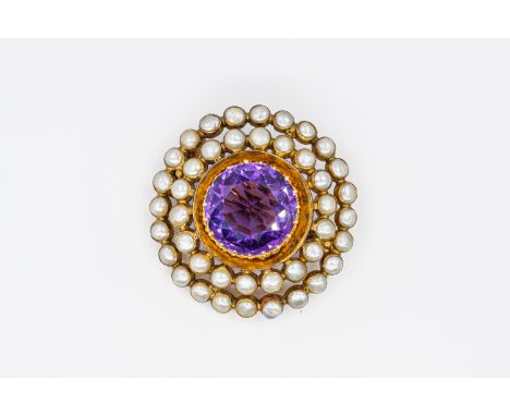 AN EDWARDIAN AMETHYST AND PEARL BROOCHWith a central claw set round amethyst, with two rows of baroque shaped half pearls, in