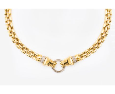 A DIAMOND SET GOLD PANTHER NECKLACEWith the form of two panther heads, with diamond set collars and ruby set eyes, holding on