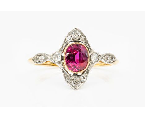 AN ART NOUVEAU RUBY AND DIAMOND RINGFeaturing a central oval ruby, in a rub over setting, with a surround of old cut diamonds