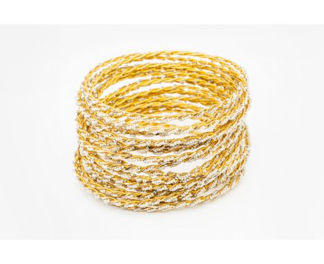 TWENTY-FOUR GOLD AND SEED PEARL BANGLESEach in a rope twist design of alternating seed pearls and gold, in unmarked yellow go