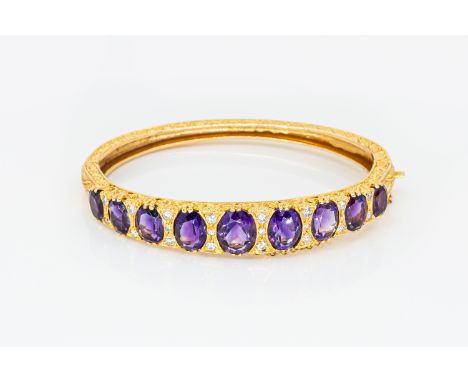 A VINTAGE AMETHYST AND DIAMOND BANGLESet with nine oval amethysts each alternating with round brilliant cut diamonds, all in 