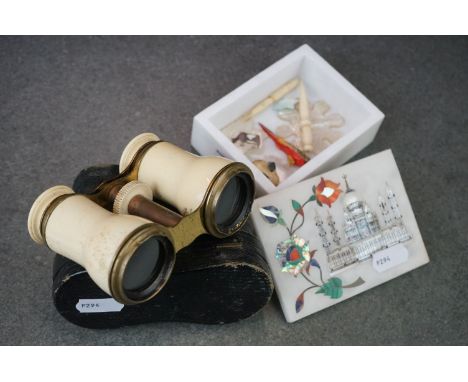 A cased set of antique opera glasses together with mother of pearl gaming counters and a decorative stone box. 