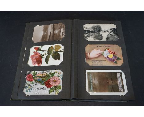 Collection of early 20th century postcards in a vintage album, to include topographical, comic, RMS Lusitania and other WW1 i