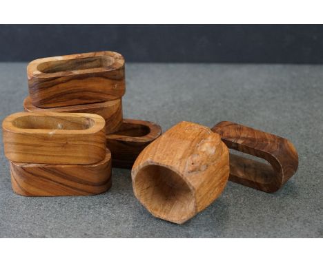 A collection of seven wooden napkin rings to include a mouseman Robert Thompson example. 