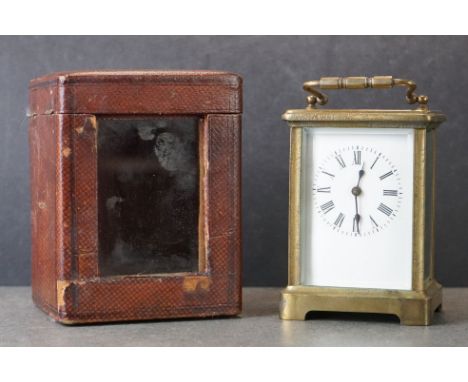 An early 20th century brass cased carriage clock, complete with travel case and key. 