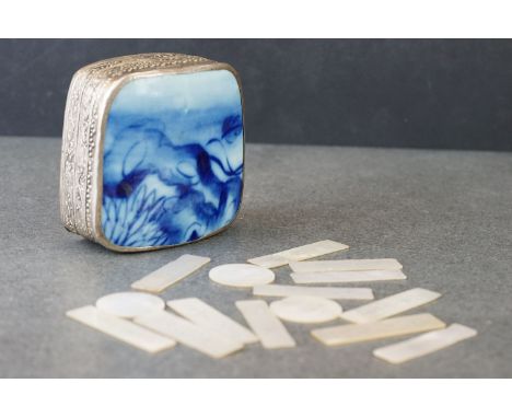 A collection of antique mother of pearl gaming counters contained within a decorative white metal box. 