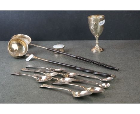 A collection of hallmarked sterling silver items to include a goblet, teaspoons, toddy labels and an enamel trinket box. 