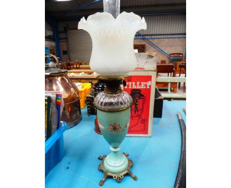 A Victorian brass glass and ceramic oil lamp with shade